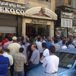 Syrians crowd around an exchange location