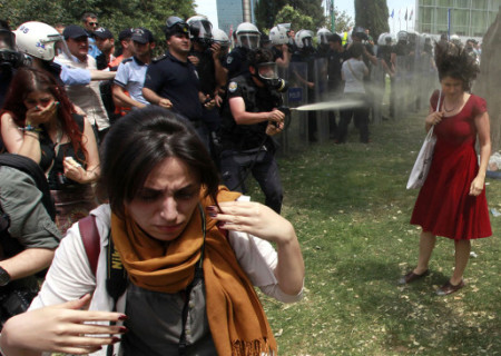 Turkish police spray woman in a red dress in the face with tear gas Gezi Park