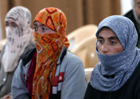 Yazidi women look on at Al-Tun Kopri health centre, located half way between the northern Iraqi city of Kirkuk and Arbil, after they were released with around 200 mostly elderly members of Iraq's Yazidi minority near Kirkuk on January 17, 2015 after being held by the Islamic State jihadist group for more than five months. Medical teams from the Kurdistan Regional Government carried out blood tests and provided emergency care to the group of Yazidis, many of whom looked sick and distraught. Yazidi officials and rights activists say thousands of members of their Kurdish-speaking community are still in captivity.